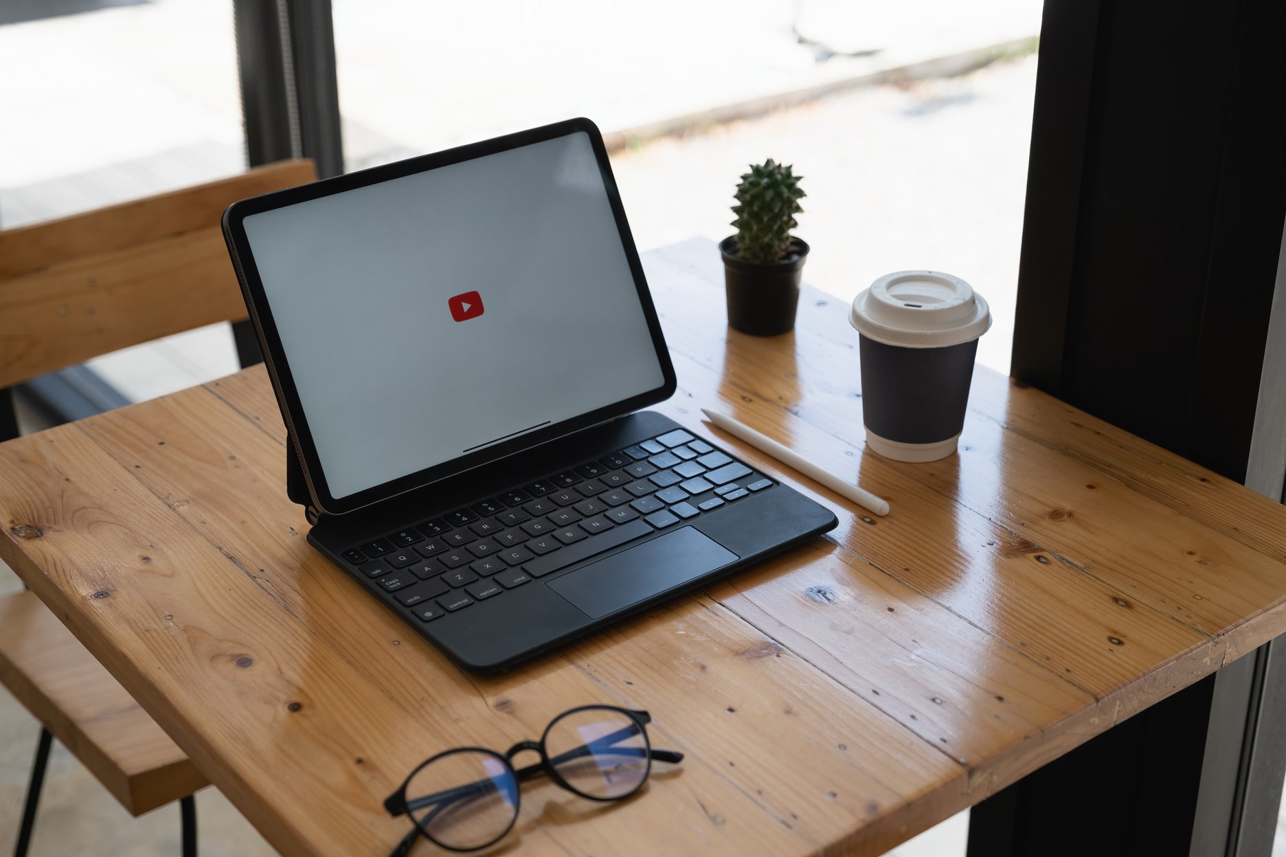 CHIANGMAI THAILAND - May 24,2021 : Apple IPad with Youtube Logo on the Screen on Wooden Desk.