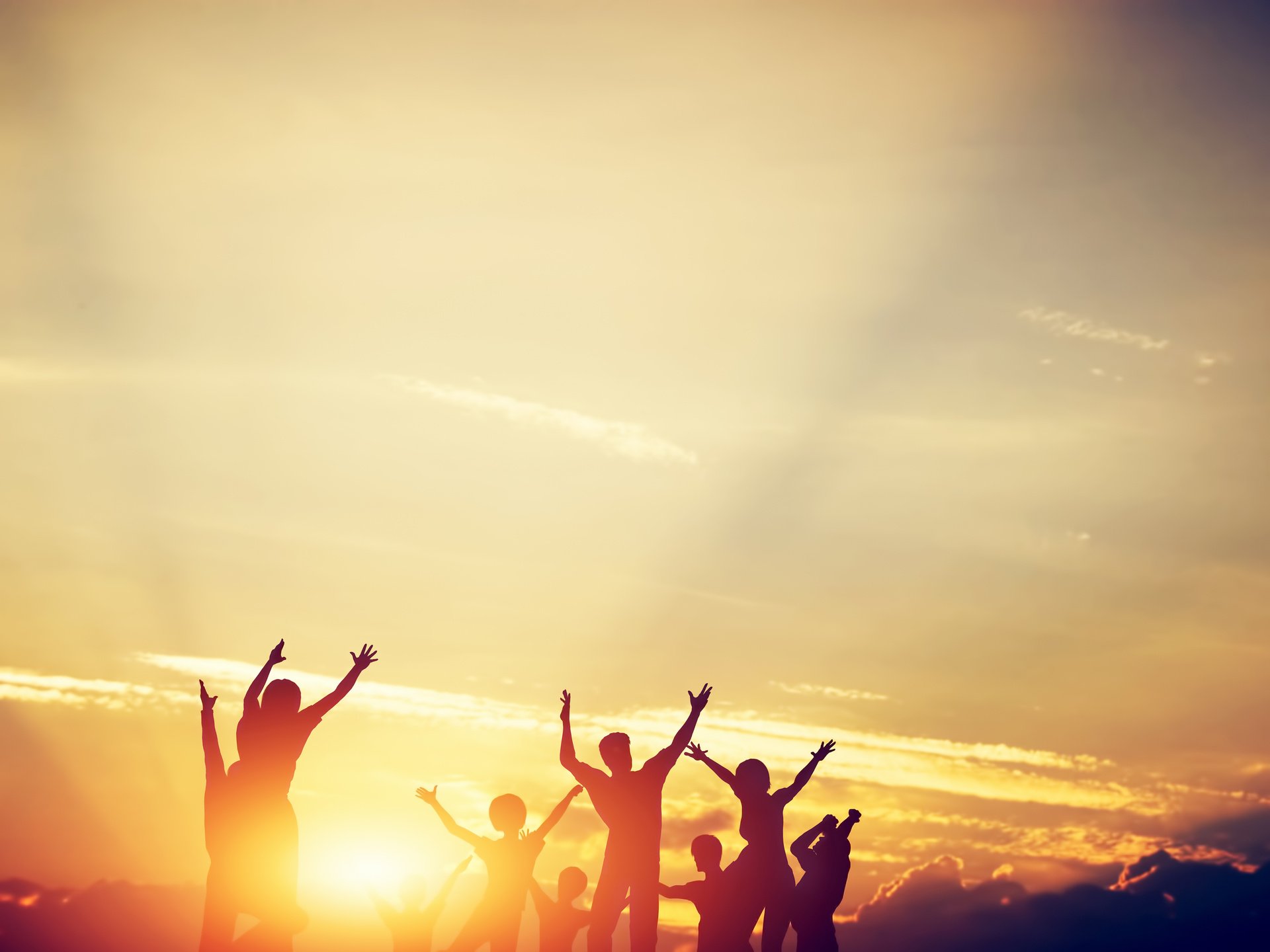 Happy Friends, Family Jumping Together at Sunset.