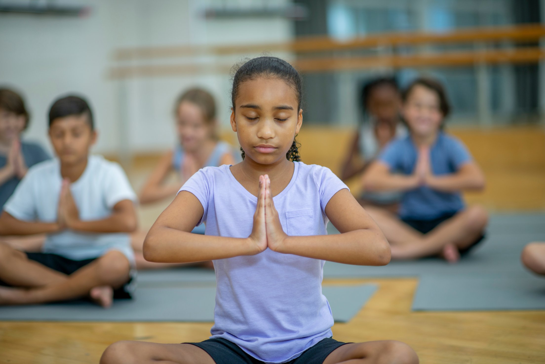 Children Meditating in a Gymnasium