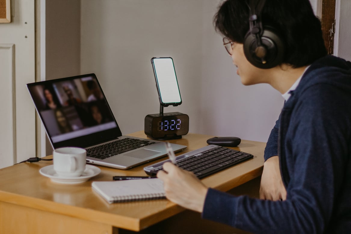 Student with Headphones Using Laptop for Online Class